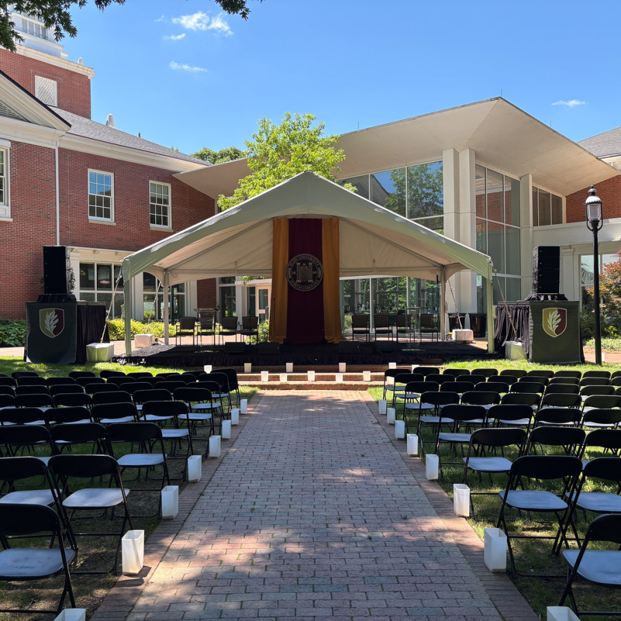 Podium of people in a tent at Elon INN