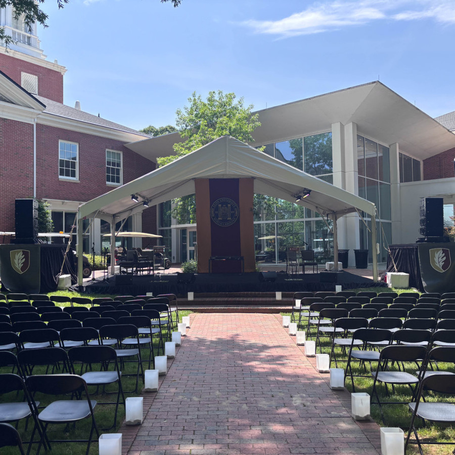 Podium of people in a tent at Elon INN